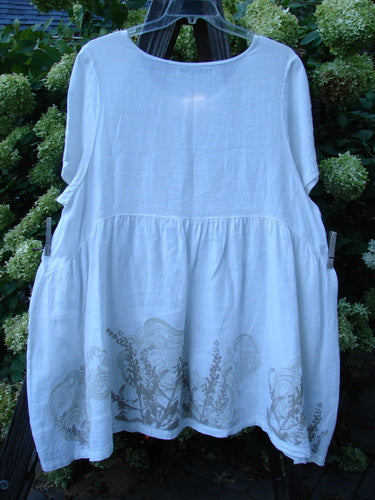 Barclay Linen Studio Pullover Dress Breeze Fern White Size 2 displayed on a hanger, featuring a flouncy lower skirt, gathered waistline, wide hem sweep, and unique figure 8 front bodice seams.