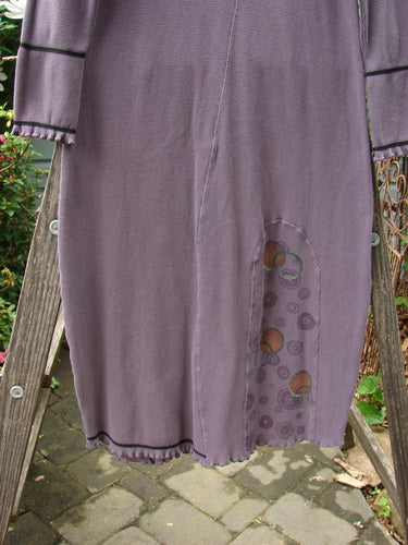 2000 Thermal Brann Dress Bubble Eggplant Size 1 displayed on a wooden ladder, featuring ruffled accents, elastic lower arm bands, and a large front pocket.