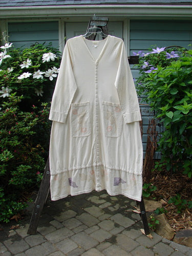 2001 T Snap Dress Game Pieces Fizz Size 1 on a rack, showcasing its heavy bottom swing, three-quarter sleeves, V-shaped neckline, painted pockets, and snap tape detailing.