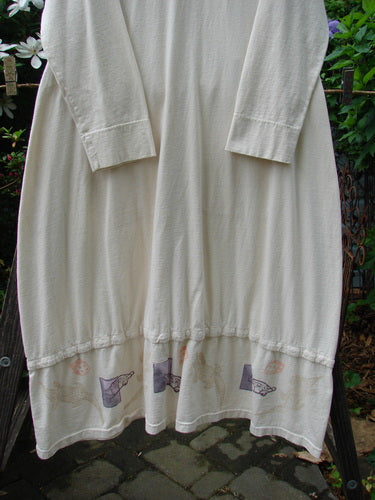 2001 T Snap Dress Game Pieces Fizz Size 1 displayed on a clothes rack, featuring three-quarter sleeves, triangular pockets, and snap tape detailing, showcasing its unique design and organic cotton fabric.