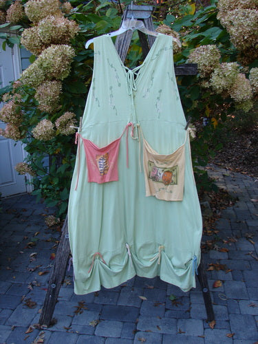 1997 Salt Water Taffy Jumper Sea Life Mellon Size 2 hangs on a rustic ladder, showcasing its bohemian style with contrasting hip pockets, lace-up detail, and gathered hem ties.