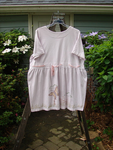 1999 Ribbon Dress Butterfly Orchid Size 2 displayed on a swinger, featuring a double-paneled rounded neckline, gathered empire waist, adjustable waistline, and butterfly-themed paint.