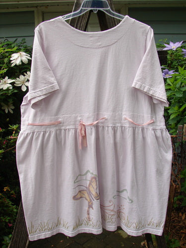 1999 Ribbon Dress Butterfly Orchid Size 2, featuring a white shirt with a pink bow, hanging on a clothesline; detailed with double-paneled neckline and waistline, bell shape, and butterfly theme paint.