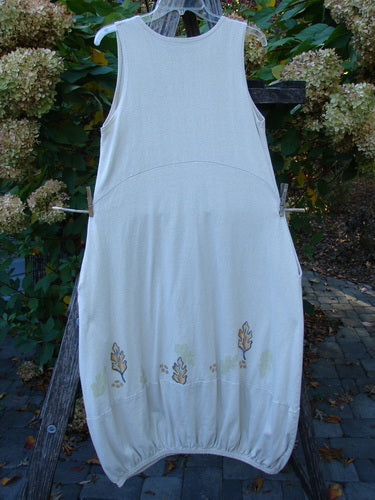 2000 Cotton Hemp Libby Jumper Falling Leaf Dove Altered Size 1: Sleeveless, knee-length dress with a ballooned hem, hand-painted autumn leaves motif, scoop waistline, side pockets, and elastic hem, showcasing elegant movement.
