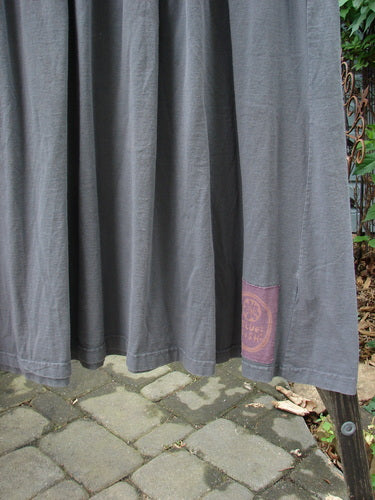 1992 Short Sleeved Simple Dress Vase Black Sand Size 1 displayed on a brick surface, featuring a semi-dropped waistline, full draping lower, rounded neckline, and unique Blue Fish patch.