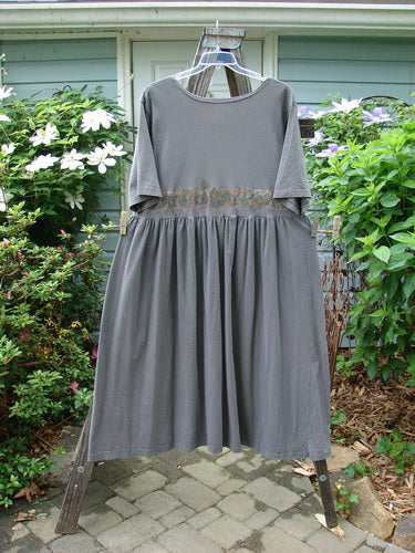 1992 Short Sleeved Simple Dress Vase Black Sand Size 1, featuring a semi-dropped waistline, full draping lower, wide rounded neckline, Blue Fish patch, and unique vase theme paint from the Holiday Collection.