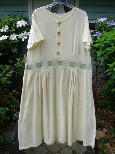 2000 LuLu's Dress Moon Window Milk Size 2: A white dress with a drop yoke waistline, two inseam pockets, pleated front darts, and a wide swingy lower, hanging on a clothesline.