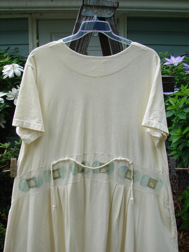 2000 LuLu's Dress Moon Window Milk Size 2 displayed on a wooden stand, featuring a drop downward yoked waistline panel, inseam pockets, button top closure, pleated front darts, and swingy lower.