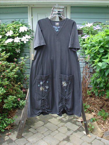2000 Nova Dress Star Flower Orbit Size 0 displayed on a clothes rack, showcasing three-quarter wide sleeves, large side pockets, reverse triangular neckline insert, and double vertical drawcord accents.