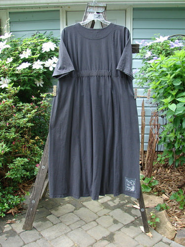 2000 Nova Dress Star Flower Orbit Size 0 displayed on a clothes rack, featuring a reverse triangular painted neckline, three-quarter sleeves, giant side drop pockets, and double vertical drawcord accents.