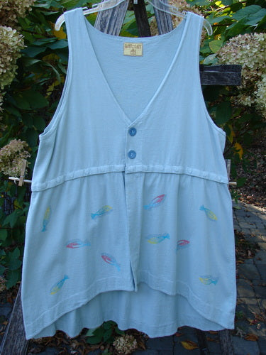 Barclay Little Tree Vest Dragonfly Fish Cucumber Size 1, sleeveless with blue buttons, features multicolored fish motifs, empire waist, and a scooped hem, hanging on a trellis outdoors.
