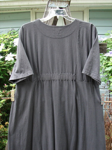 2000 Nova Dress Star Flower Orbit Size 0 on a clothes rack, featuring a reverse triangular painted neckline, three-quarter length wide sleeves, giant side drop pockets, and double vertical drawcord accents.