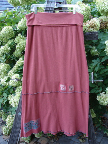 Barclay Patched Thermal Fold Over Ruffle Panel Skirt Autumn Size 2 displayed on a wooden rack, featuring horizontal stitches, tiny patches, and coordinating stripes.