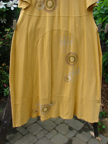 1998 Croquet Dress Lawn Games Lemonade Size 2 hung on a clothesline, showcasing unique front and back inserts, a shallow rolled neckline, and a heavy continuous bottom panel.