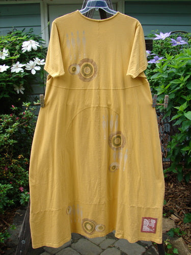 1998 Croquet Dress Lawn Games Lemonade Size 2 hanging on a clothesline, featuring a shallow rolled neckline, sectional vertical rounded panels, and a heavy continuous bottom panel with a sweeping A-line shape.