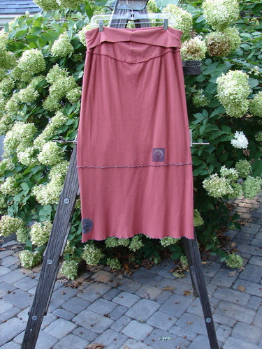 Barclay Patched Thermal Fold Over Ruffle Panel Skirt Autumn Size 2 displayed on a rack, showcasing its fold over waistline, horizontal stitchery, and tiny patches along the hem panel.