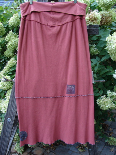 Barclay Patched Thermal Fold Over Ruffle Panel Skirt Autumn Size 2 displayed on a clothes rack, showcasing its distinctive horizontal stitchery, tiny patches along the hem, and coordinating stripes.