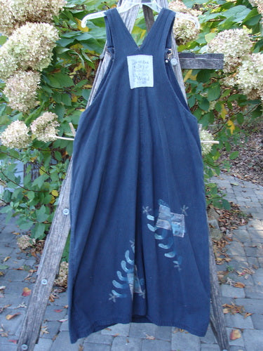 1996 Denim Overall Jumper Truck Travel Black Size 1 displayed on a trellis outdoors, featuring a V-neck front bib with a painted pocket, adjustable straps, and metal side buttons, showcasing unique motifs near the hem.