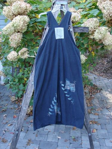 1996 Denim Overall Jumper Truck Travel Black Size 1, displayed on a wooden ladder. Features wide legs, crossed straps, painted foliage motifs, and a front bib pocket, embodying vintage Blue Fish creativity.