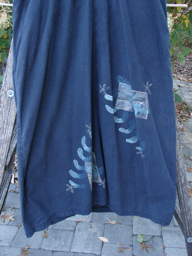 1996 Denim Overall Jumper Truck Travel Black Size 1 displayed draped on an outdoor bench, showcasing stylized lizard motifs and blue fabric patches near the hem, with adjustable shoulder straps and metal button accents.