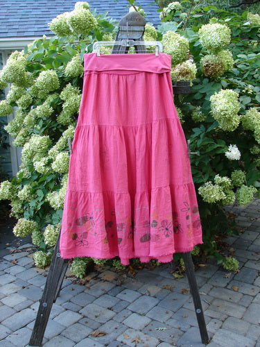 Barclay Linen Fold Over Three Tier Skirt Daisy Flamingo Size 2 displayed on a rack, showcasing its triple horizontal tiers and frayed lower hem.