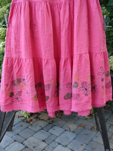 Barclay Linen Fold Over Three Tier Skirt Daisy Flamingo Size 2, featuring triple horizontal tiers, a full cotton lycra waistband, and a frayed lower batiste hem, displayed against an outdoor setting.