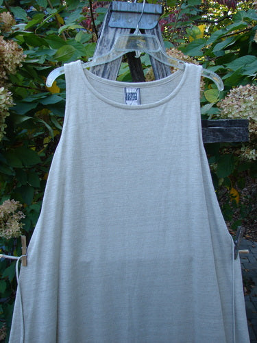 1998 Linen Knit Wrap Dress Unpainted Natural Size 2 hanging outdoors, showcasing its sleeveless, flowing linen design with a rounded neckline and slender drape, embodying BlueFishFinder's vintage elegance and creative freedom.