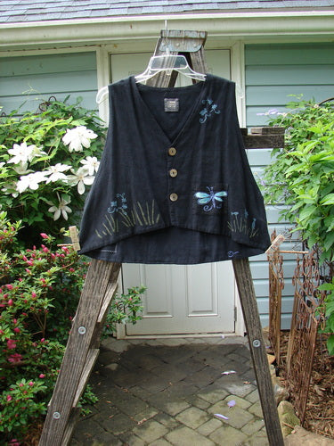 1999 Textured Linen Sunfish Vest Dragonfly Field Raven Size 1, featuring blue dragonflies and flowers, three pearly buttons, an A-line shape, and a scooped front hemline, hanging outdoors.