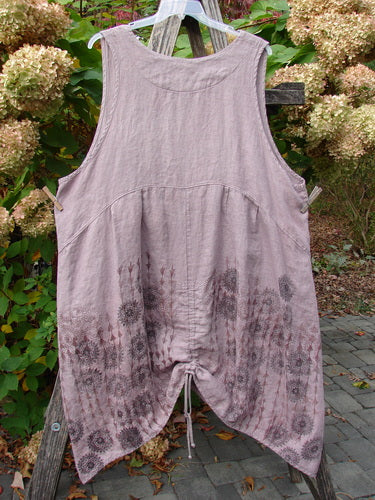 Barclay Linen Pleated Pocket Pinafore Mandala Soft Mauve Size 2, featuring a sleeveless design, V-neckline, subtle floral pattern, pleats at the empire waist, and adjustable drawstrings for a tailored fit.