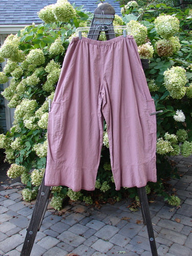 Barclay Linen Spring Flutter Pant Unpainted Rosey Peony Size 2 displayed on a rack, showcasing sectional panels, lower side drop pockets, and a larger elastic waistline in medium-weight denim-like linen.