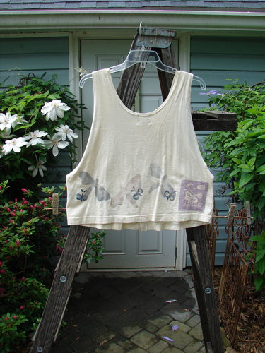 1999 Pinwheel Vest All Butterflies Dust Size 0 displayed on a wooden ladder, featuring butterfly patterns, porcelain buttons, and a slightly flared hemline, exemplifying Blue Fish Clothing's vintage, organic cotton design.