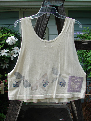 1999 Pinwheel Vest All Butterflies Dust Size 0: White tank top with butterfly pattern, deeper arm openings, slightly flared hemline, three front buttons, and Blue Fish patch, from Summer Collection of 1999.
