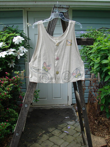 1999 Pinwheel Vest Butterfly Wind Dust Size 0 displayed on a wooden ladder, featuring three porcelain buttons, flared hemline, deeper arm openings, and butterfly theme design from Bluefishfinder.com’s vintage collection.