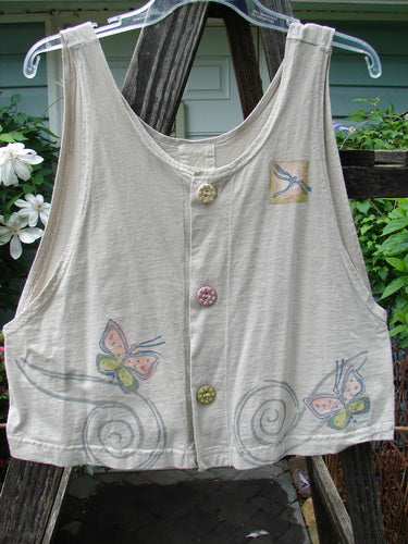 1999 Pinwheel Vest Butterfly Wind Dust Size 0: White vest featuring painted butterflies, deep arm openings, flared hemline, and porcelain buttons. Part of Blue Fish Clothing's vintage collection, emphasizing unique, organic designs.