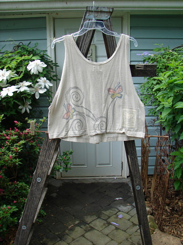 1999 Pinwheel Vest Butterfly Wind Dust Size 0 displayed on a wooden ladder, featuring three porcelain buttons, deeper arm openings, a slightly flared hemline, and butterfly-themed design.