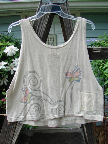 1999 Pinwheel Vest Butterfly Wind Dust Size 0: A white tank top featuring butterfly and windy day designs, deeper arm openings, flared hemline, and three porcelain buttons, embodying Blue Fish's vintage charm.