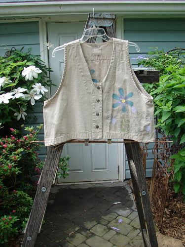 2000 Parachute Cross Stitch Vest Sunrise Floral Dove Size 0 features a deep V-neckline, four metal button closures, and a bright floral theme, hanging outdoors on a line.