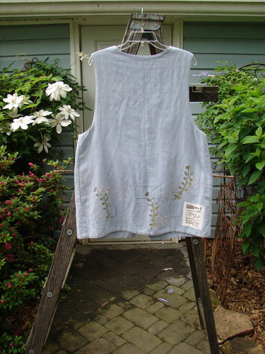 1999 Textured Linen 2 Pocket Vest Undersea Water Size 0 displayed on a wooden rack, highlighting its unique floral design, deep arm openings, oversized front painted pockets, and 5 pearl buttons.