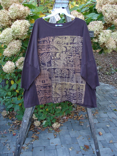 Barclay NWT Modern Square Top Metallic Village Loam Ogo OSFA displayed on a wooden ladder, showcasing dolman shoulders, a wide neckline, and a block-style graphic with village motifs in tan tones.