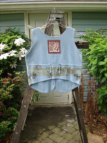 1993 The Vest Wind Garden Periwinkle Altered Size 1 displayed on a wooden rack, featuring tuxedo-style front tails, original blue buttons, and a heart signature patch.