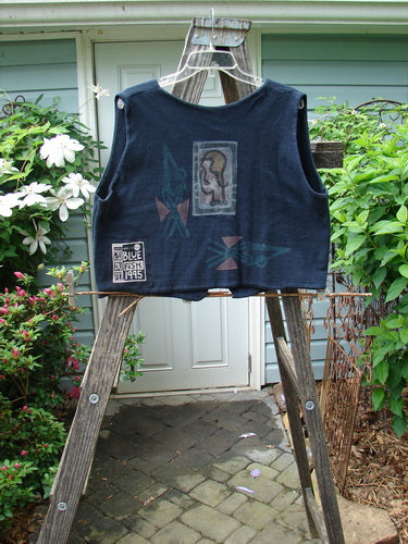 1995 Reprocessed Jazz Vest Mystery Gal Black Altered Size 2, displayed on a wooden ladder, featuring a deep V neck, single button closure, bright blue fish patch, and artistic paint details.