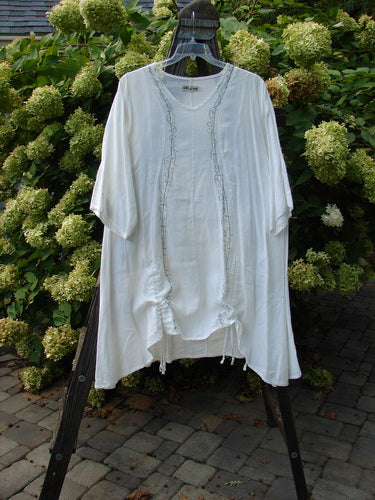 Barclay Linen Venetian Vented Tunic Dress String of Light White Size 1 displayed on a hanger, showcasing its feminine shape, softly dipped V neckline, and high side vents.
