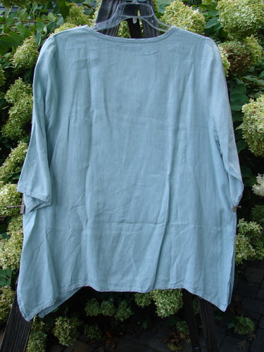 Barclay Linen Cross Dye T Top Unpainted Sage Size 1 displayed on a hanger, showcasing its A-line shape, slightly smaller back shoulder line, and sweet little side vents.