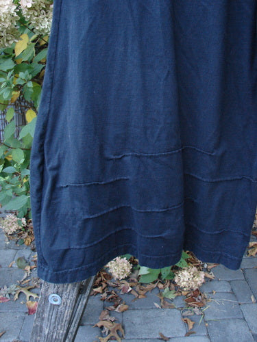 Barclay Two Pocket Pinch Cuff Wide Leg Pant Unpainted Black Size 2, elegantly hanging, showcases horizontal seam details and a slight crop length, set against a natural outdoor backdrop.