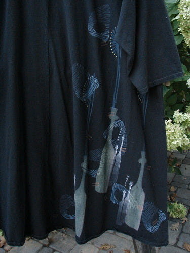 Barclay Hi Low Tunic Top Tall Neck Bottle Black Altered Size 2 with a bottle-themed print, rounded neckline, varying hemline, A-line shape, and three-quarter sleeves. Made from organic cotton.