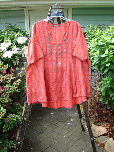 Barclay Linen Cotton Basket Weave Draw Back Tunic in Unpainted Sherbert, Size 2, displayed on a clothes hanger outdoors.