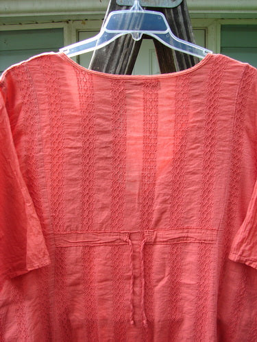 Barclay Linen Cotton Basket Weave Draw Back Tunic Unpainted Sherbert Size 2 on a clothes hanger, showcasing its short sleeves and textured fabric.