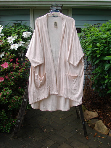 Barclay NWT Art Kimono Wind Dust Hush Pink Slub OSFA displayed on a swing, featuring dolman sleeves.