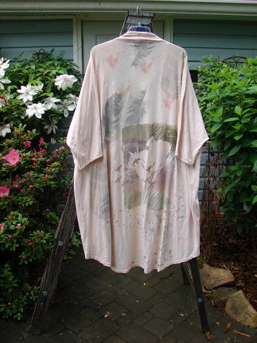 Barclay NWT Art Kimono Wind Dust Hush Pink Slub OSFA displayed on a hanger, featuring distinctive dolman sleeves and intricate patterns, exemplifying the unique vintage style of BlueFishFinder.com.