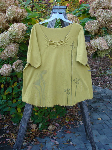 Barclay Gather Twinkle Top Berry Rise Yellow Olive Size 2 draped on a stand, showcasing a loose fit with gathered neckline, minimalist botanical print, and curly edgings, embodying Bluefishfinder.com's vintage style.